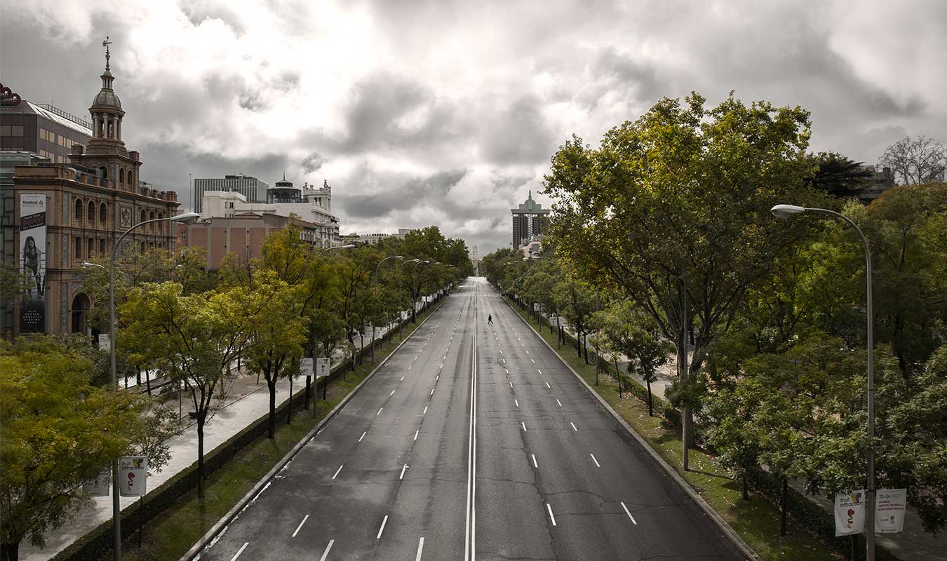 Foto del Paseo de la Castellana en Madrid con una sola persona cruzando por el medio de la calle